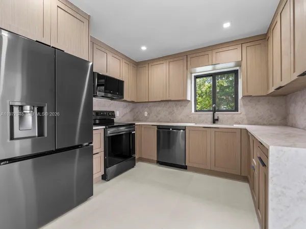 a kitchen with a refrigerator sink and microwave