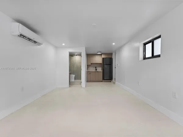 a view of an empty room with a cabinet