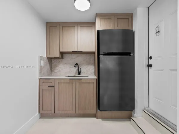 a kitchen with a refrigerator and cabinets