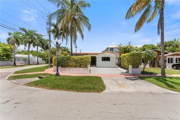 a house with palm tree in front of it