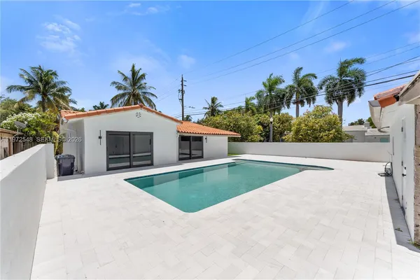 a view of a house with palm trees