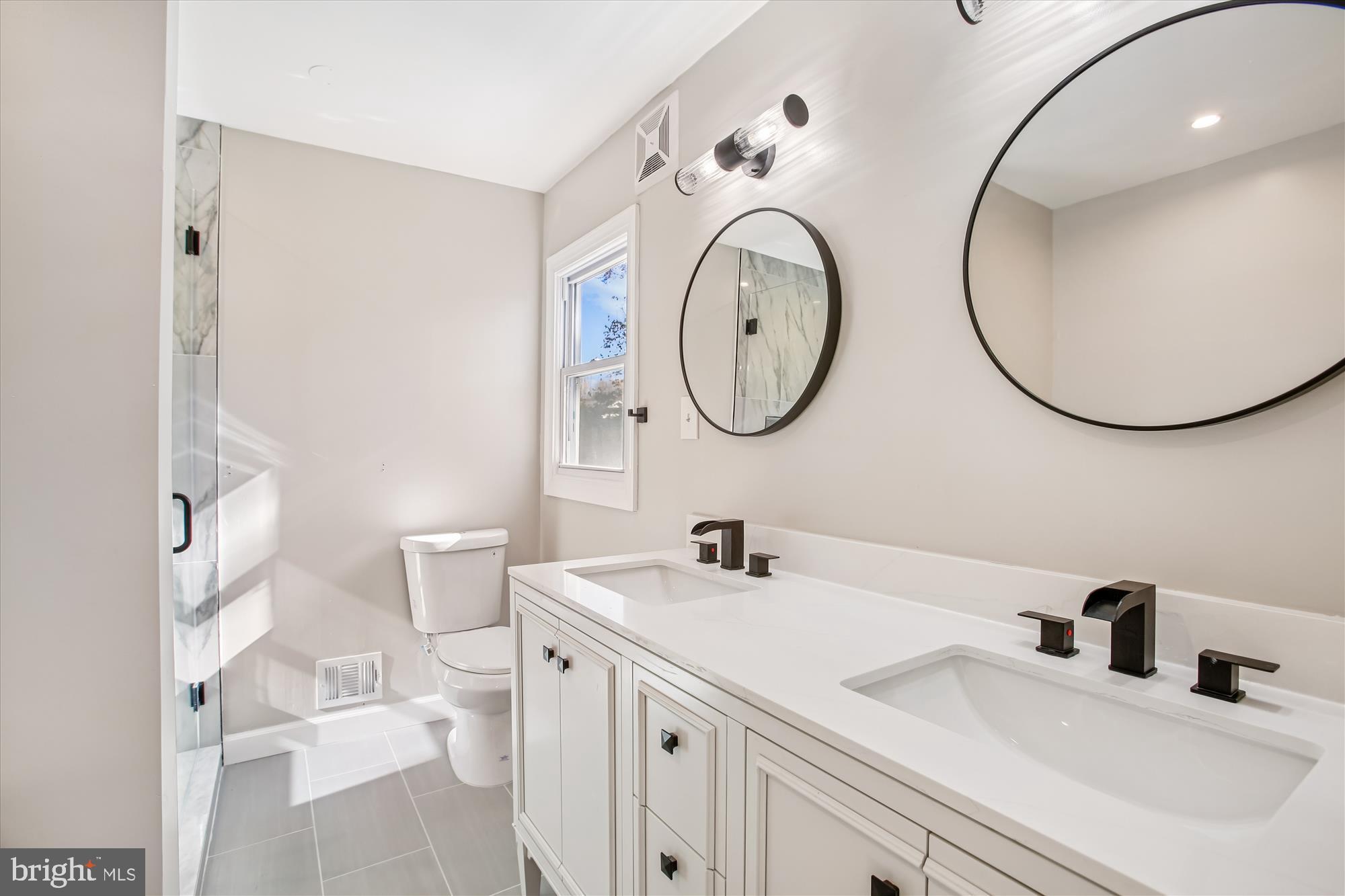 9075 Andromeda Drive Burke, VA 22015 - Photo 18 of 30 Sleek modern bathroom with elegant finishes.