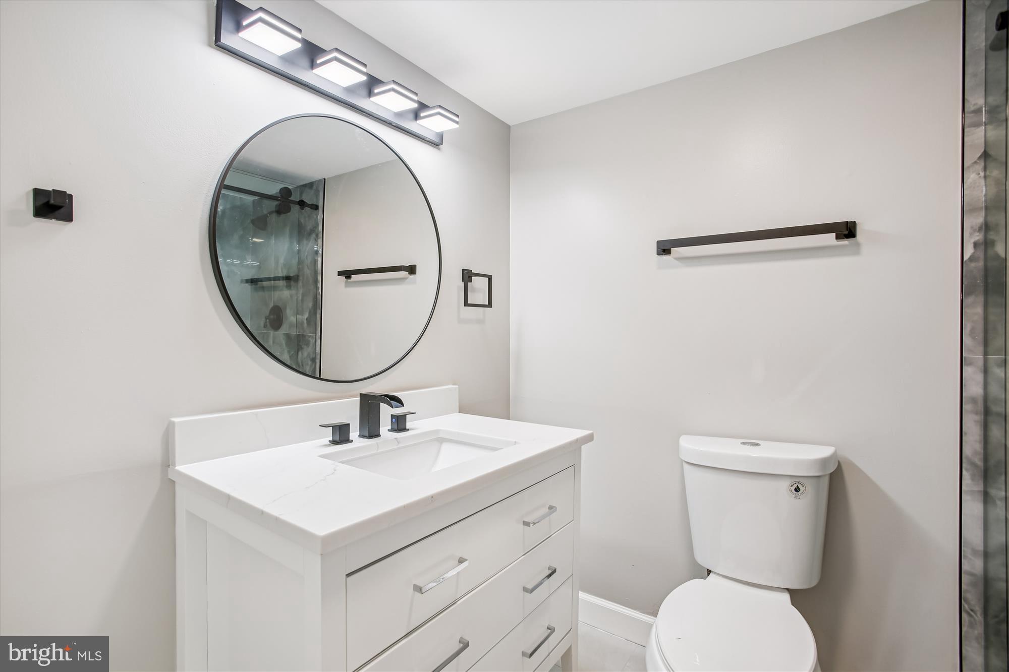9075 Andromeda Drive Burke, VA 22015 - Photo 23 of 30 a bathroom with a toilet sink and mirror