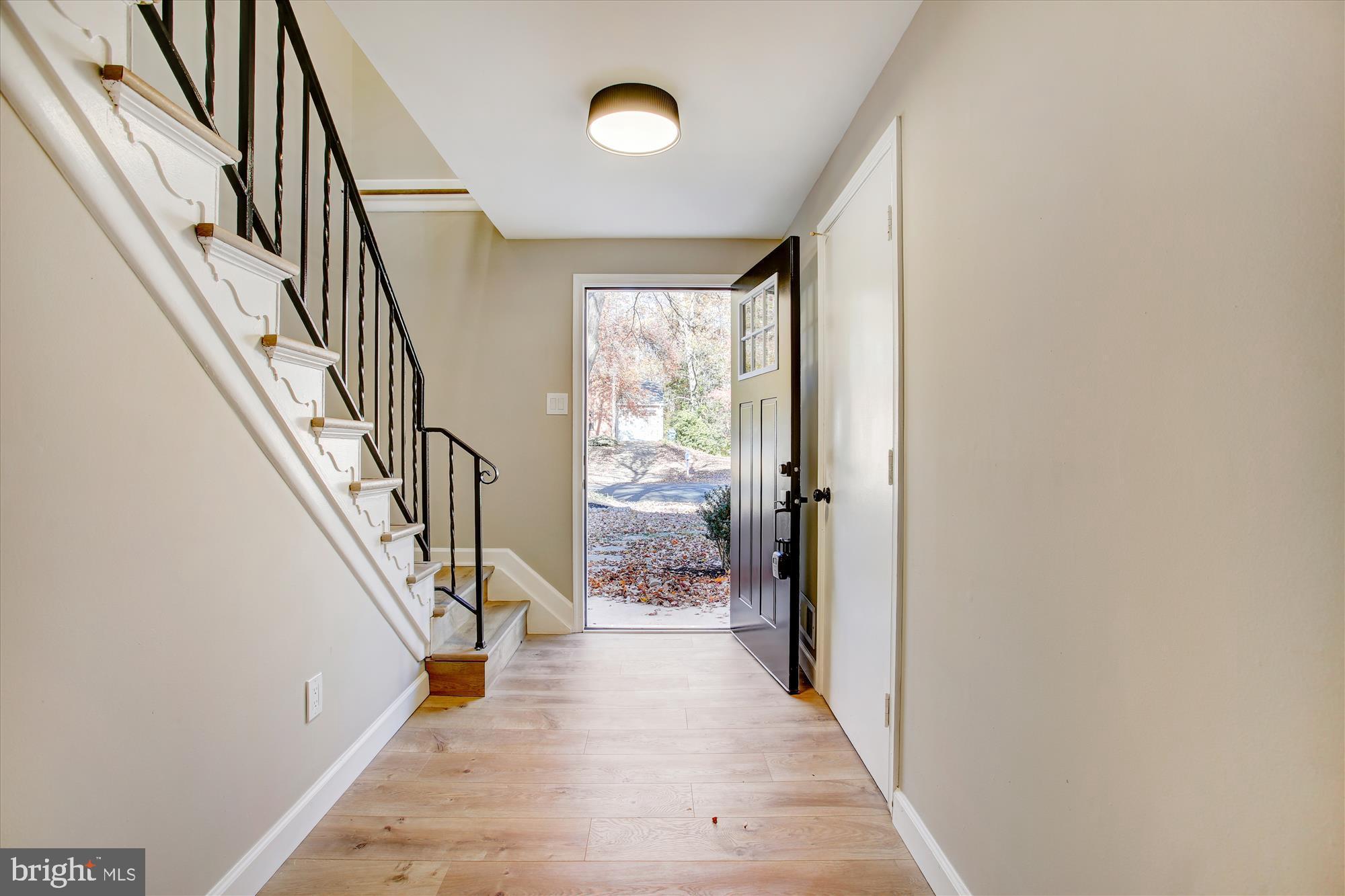 9075 Andromeda Drive Burke, VA 22015 - Photo 3 of 30 a view of hallway with wooden floor and stair