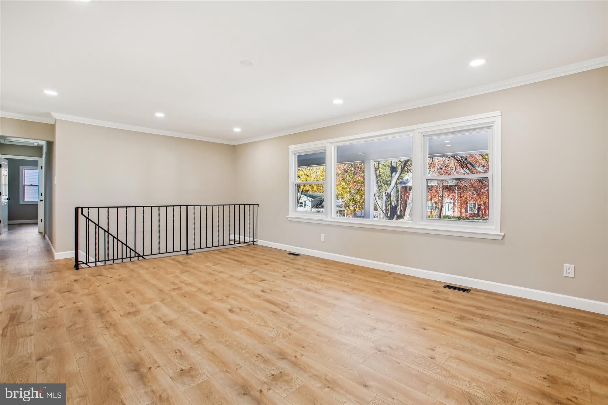 9075 Andromeda Drive Burke, VA 22015 - Photo 4 of 30 a view of an empty room with wooden floor and a window
