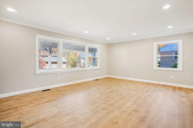 a view of an empty room with a window and closet