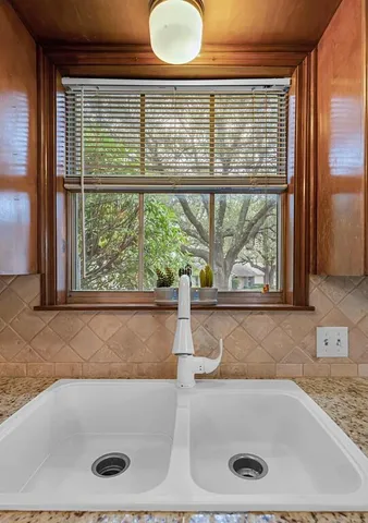a bathroom with a tub and window