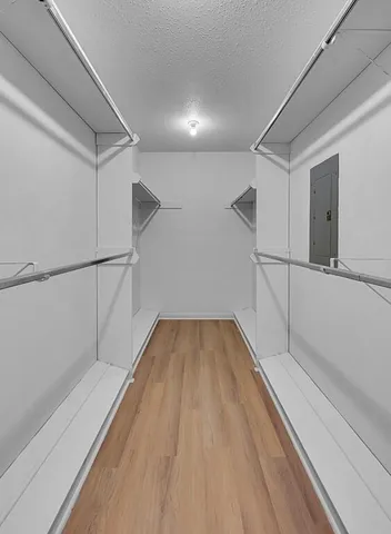 a view of a room with wooden floor