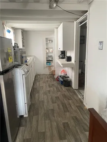 a room with furniture a washer and dryer