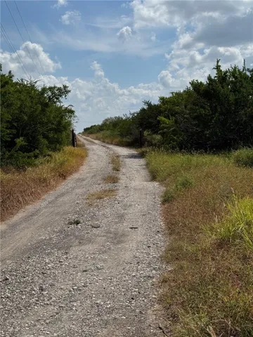 a view of a lake with beach and green space