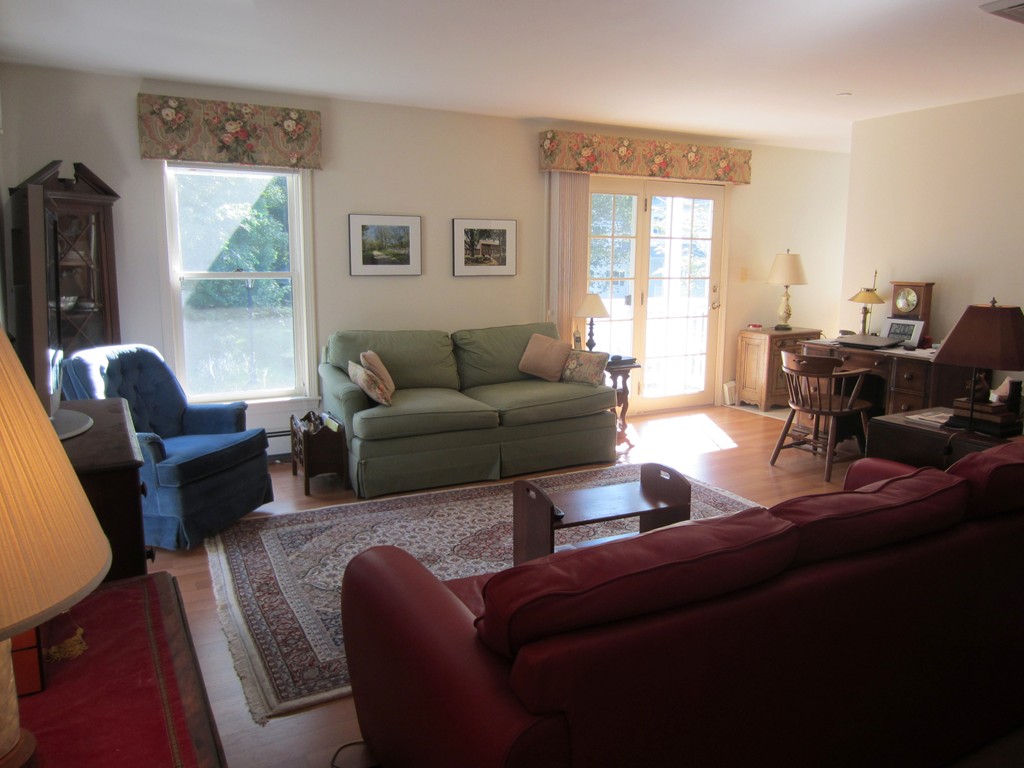 140 Lincoln Road, Unit 216 Lincoln, MA 01773 - Photo 3 of 7 a living room with furniture and a large window