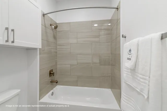 a bathroom with a shower and a toilet