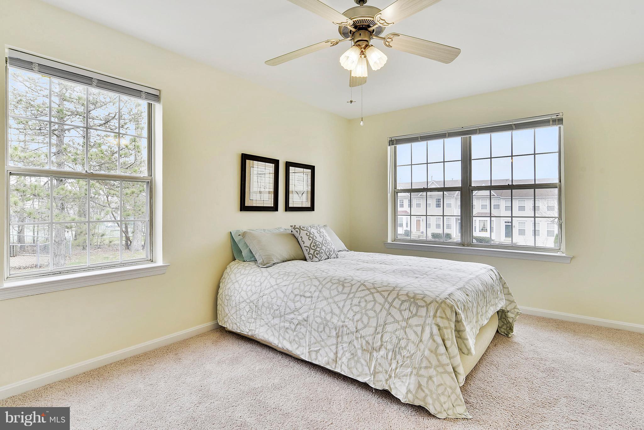 14802 Rydell Road, Unit 202 Centreville, VA 20121 - Photo 11 of 27 a bedroom with a large bed and a chandelier