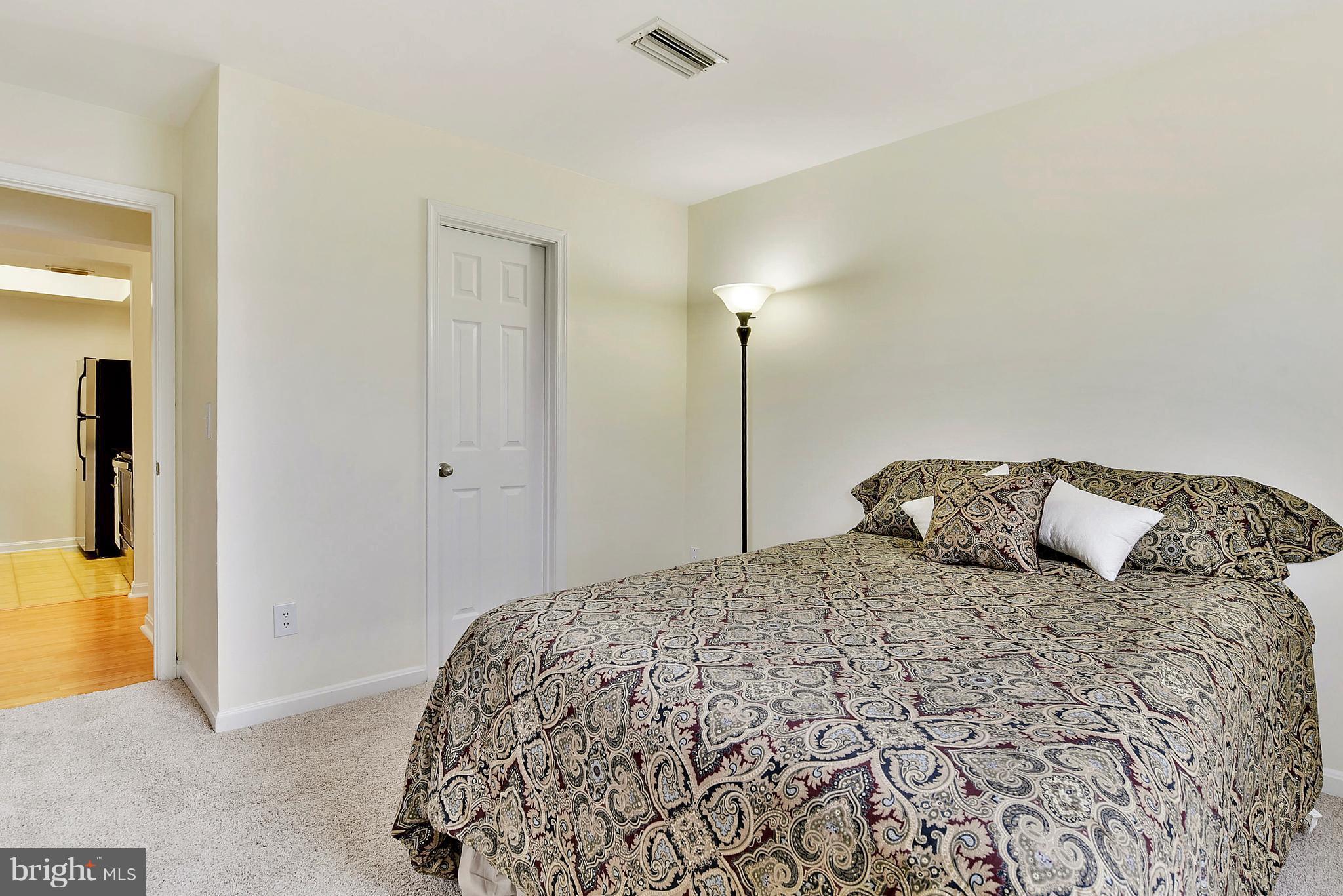 14802 Rydell Road, Unit 202 Centreville, VA 20121 - Photo 15 of 27 a bedroom with a large bed and a chandelier