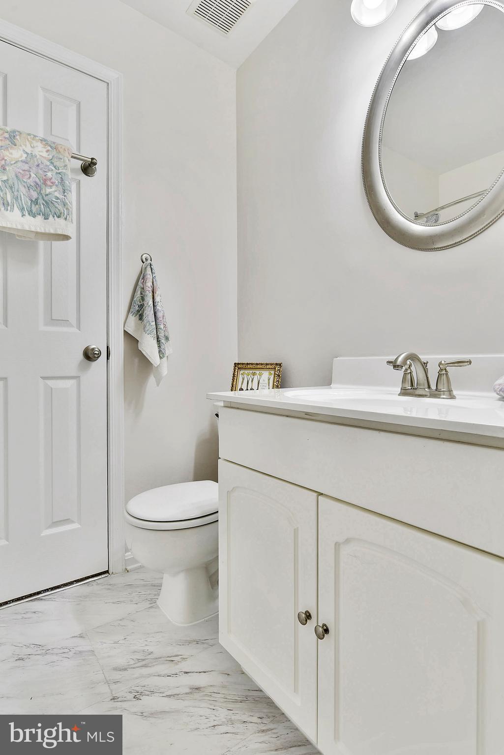 14802 Rydell Road, Unit 202 Centreville, VA 20121 - Photo 19 of 27 a bathroom with a sink a toilet and a mirror