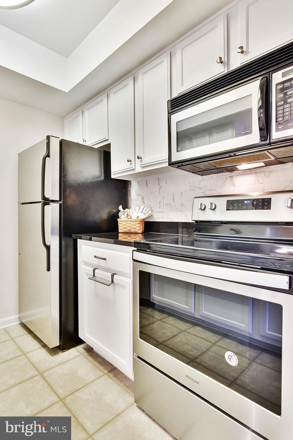 14802 Rydell Road, Unit 202 Centreville, VA 20121 - Photo 3 of 27 a kitchen with appliances and cabinets
