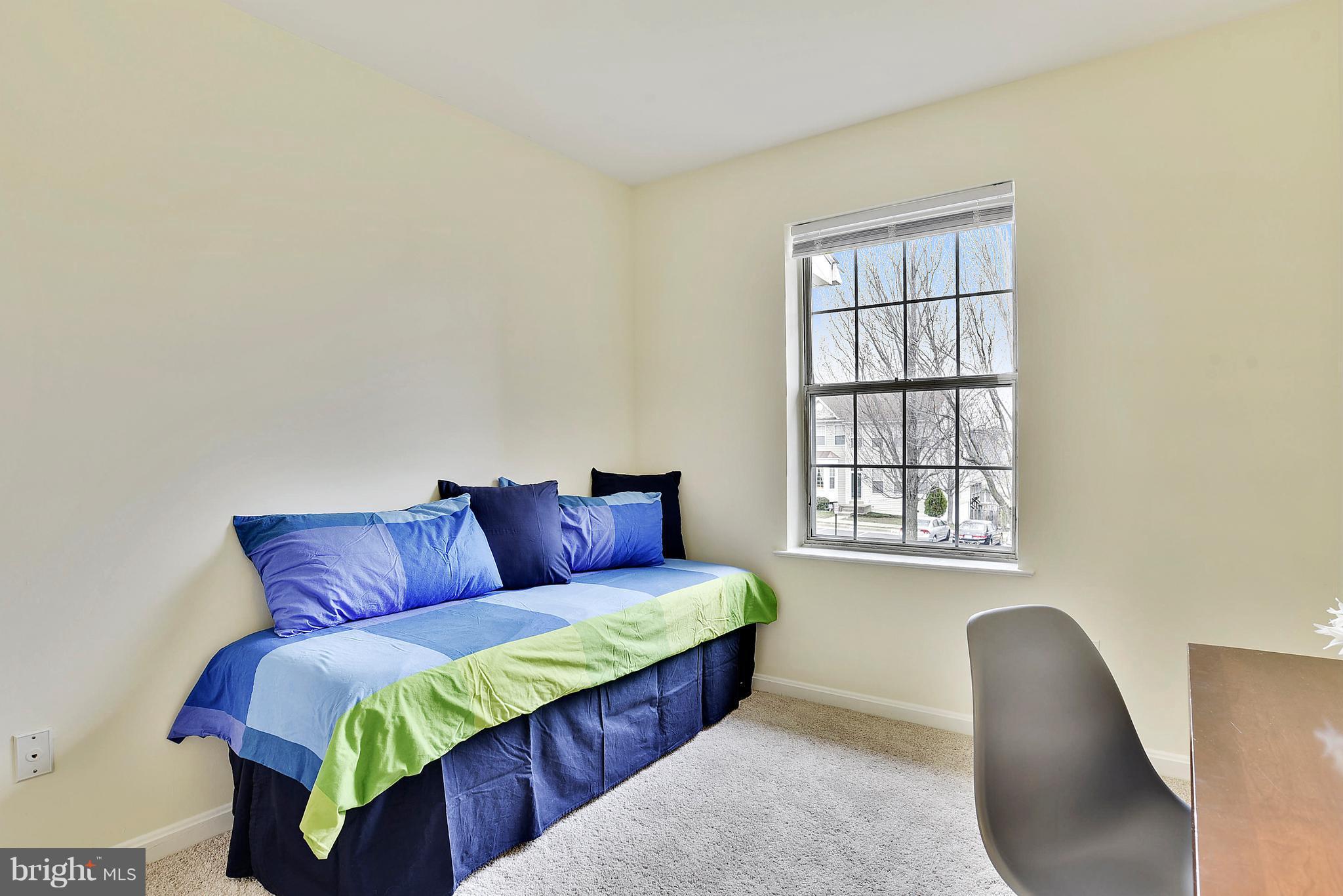 14802 Rydell Road, Unit 202 Centreville, VA 20121 - Photo 21 of 27 a large couch sitting in a bedroom next to a window