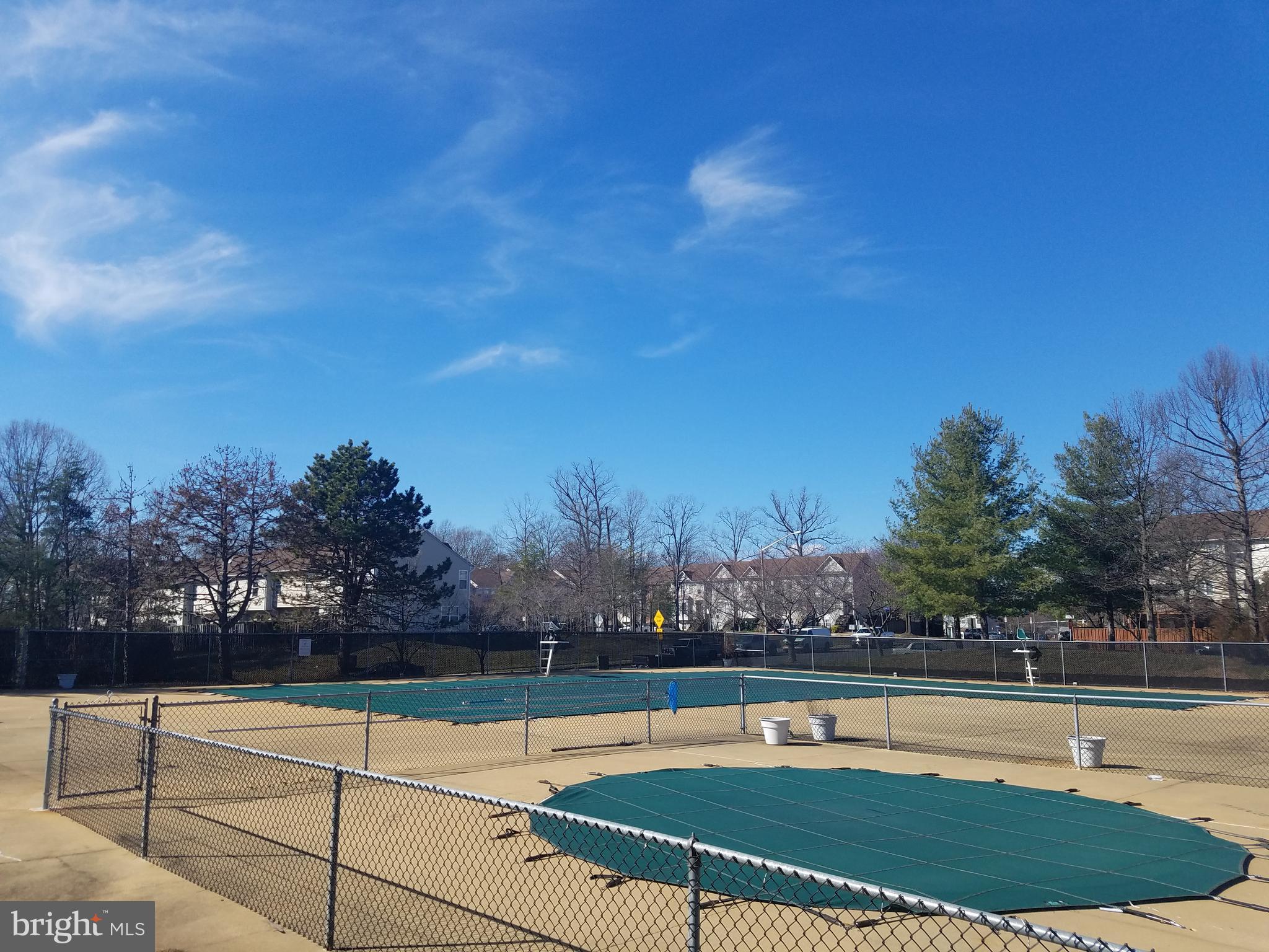 14802 Rydell Road, Unit 202 Centreville, VA 20121 - Photo 26 of 27 a view of swimming pool with seating space and trees in the background