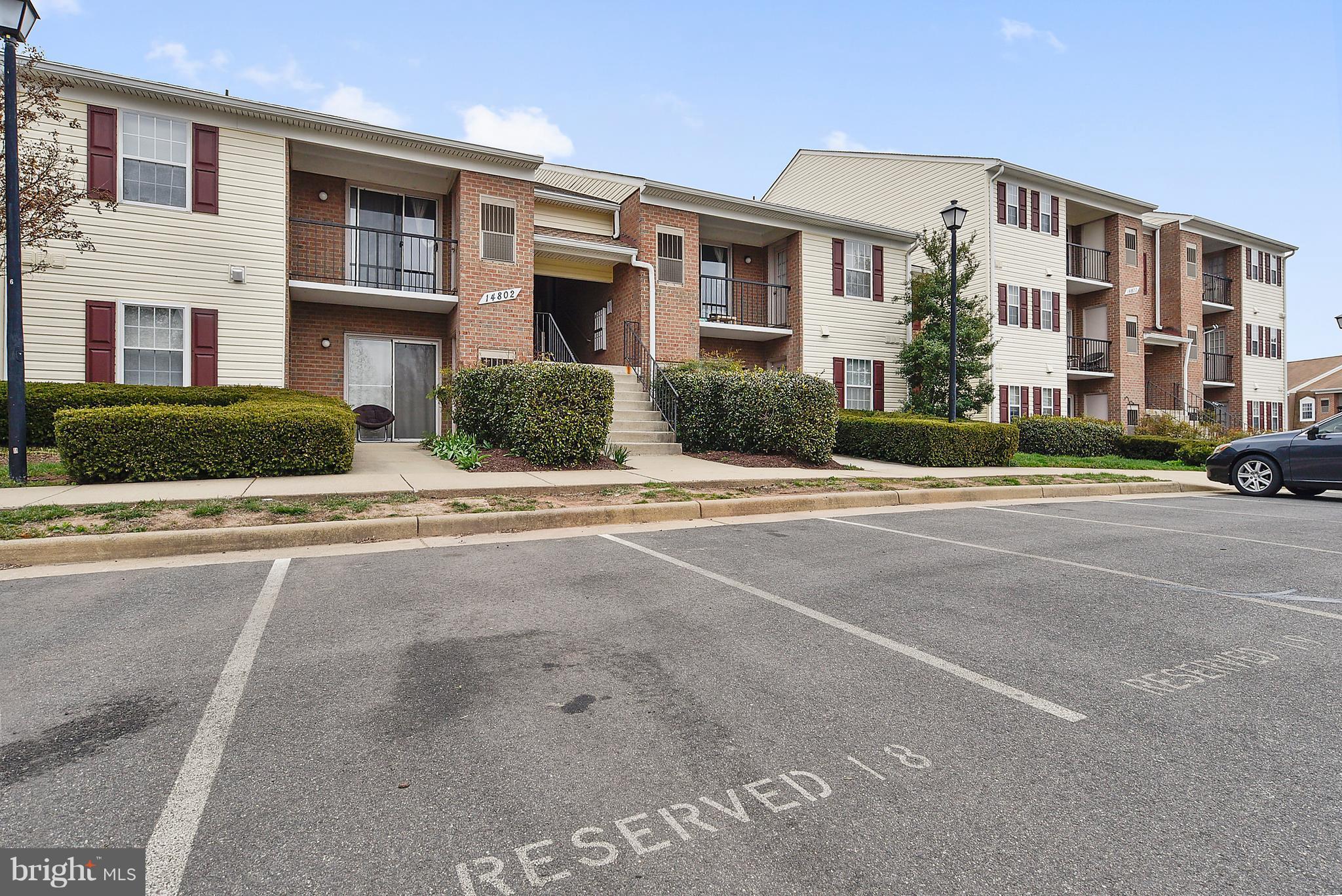14802 Rydell Road, Unit 202 Centreville, VA 20121 - Photo 27 of 27 a front view of a building with lot of cars parked on road