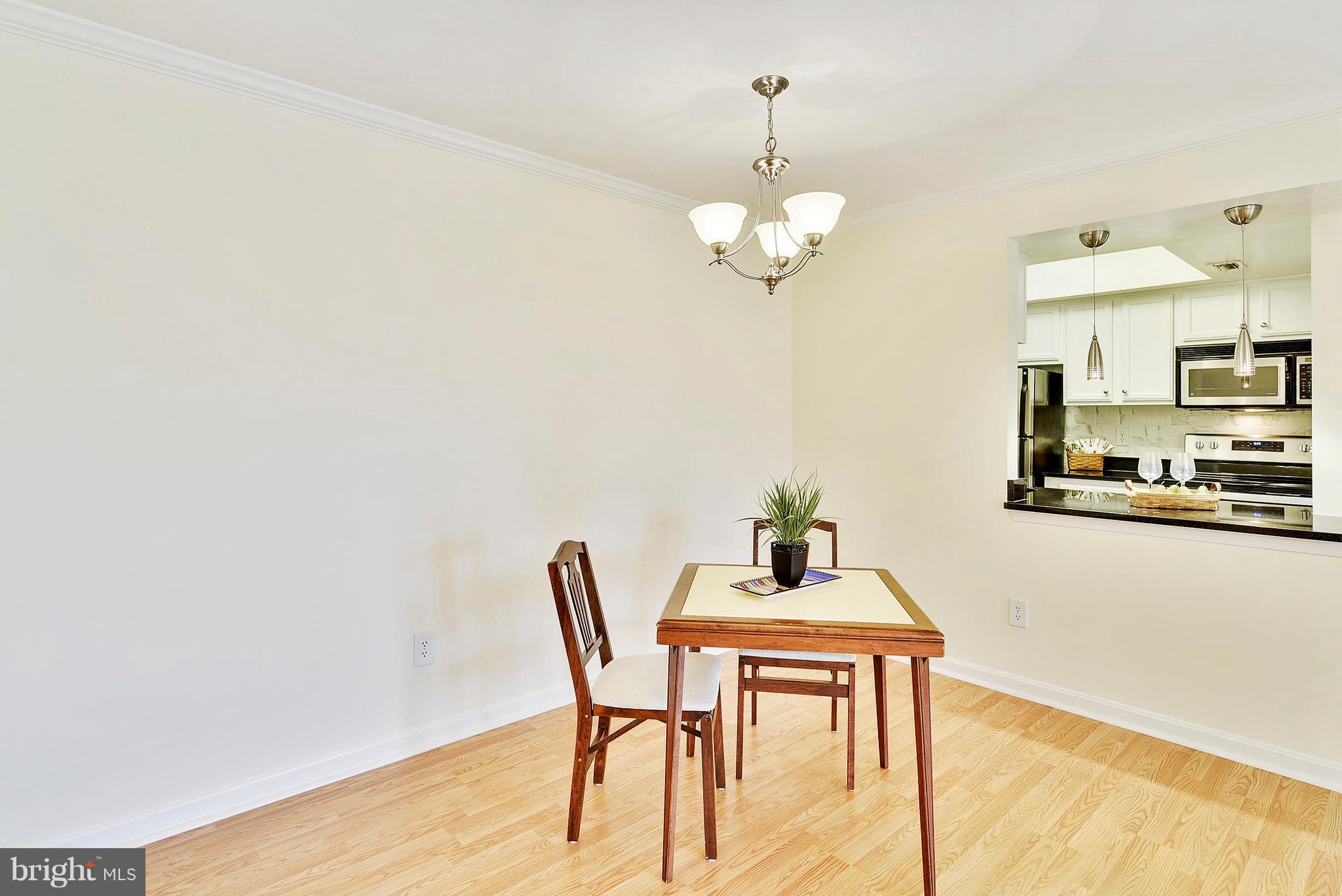 14802 Rydell Road, Unit 202 Centreville, VA 20121 - Photo 4 of 27 a view of a dining room with furniture and wooden floor