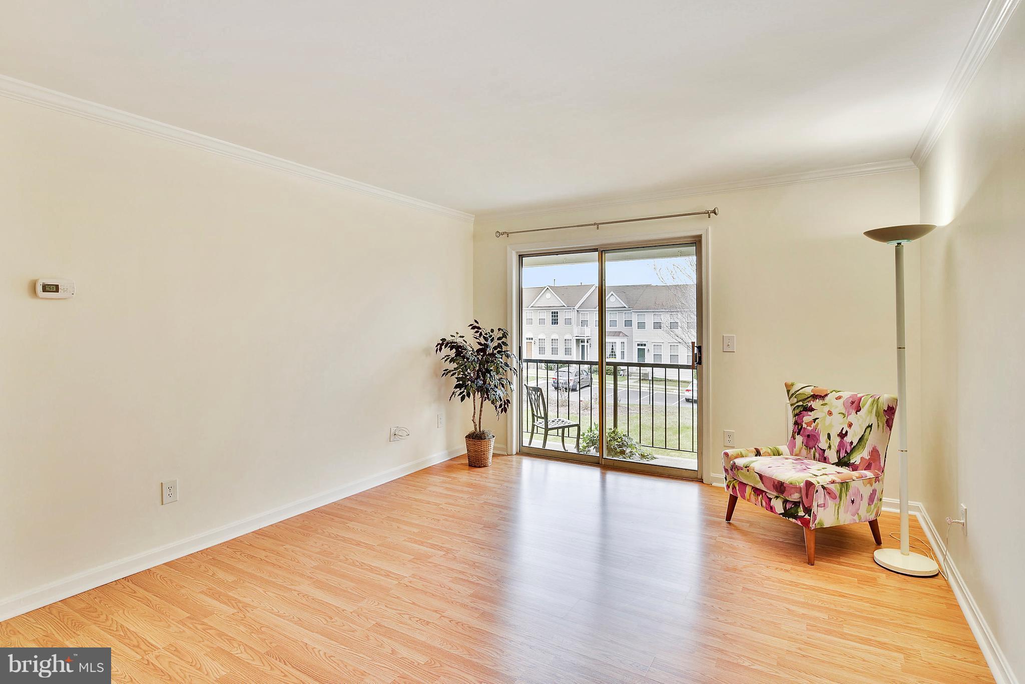 14802 Rydell Road, Unit 202 Centreville, VA 20121 - Photo 5 of 27 a view of a room with wooden floor and a window