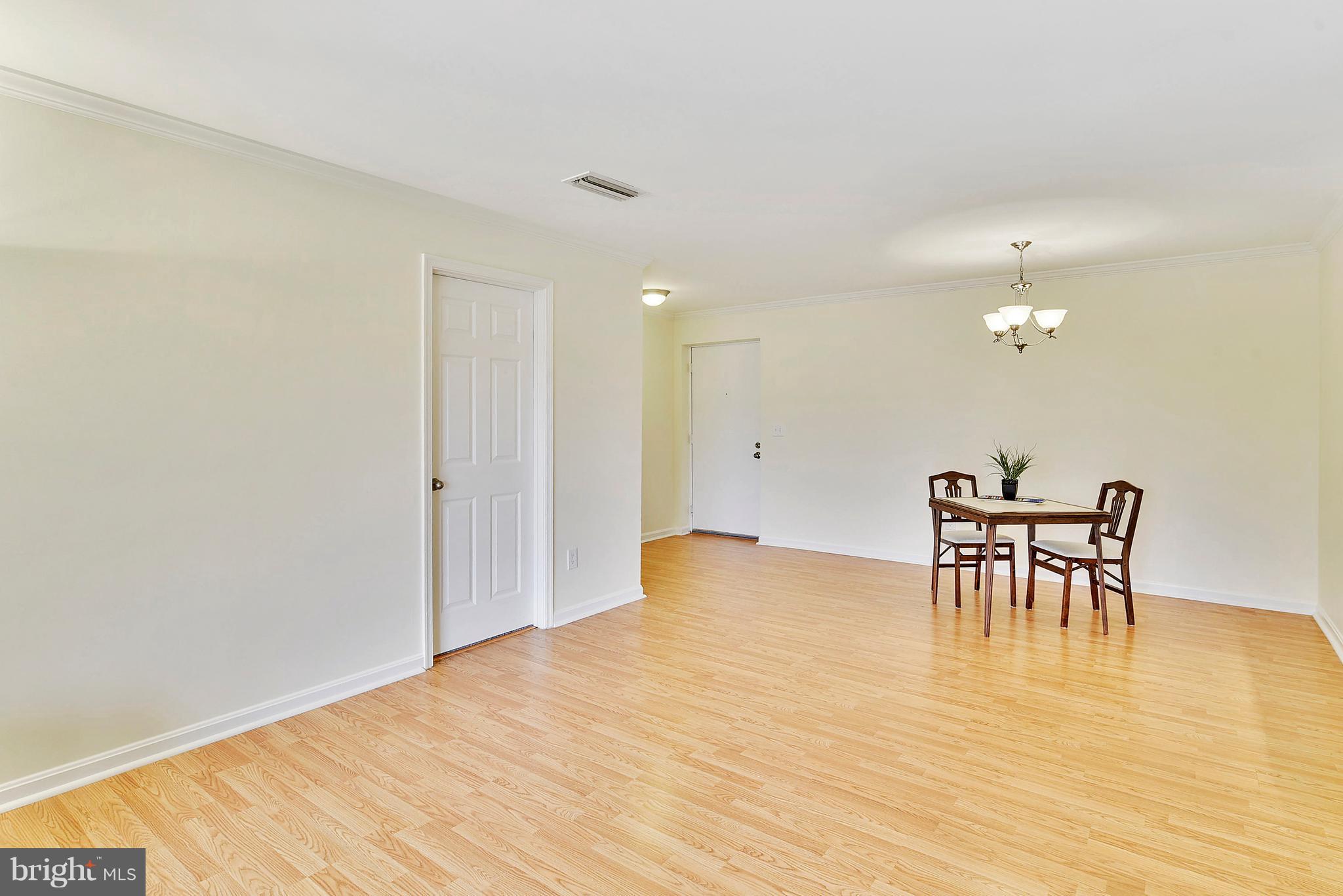 14802 Rydell Road, Unit 202 Centreville, VA 20121 - Photo 7 of 27 a view of a dining room with furniture and wooden floor