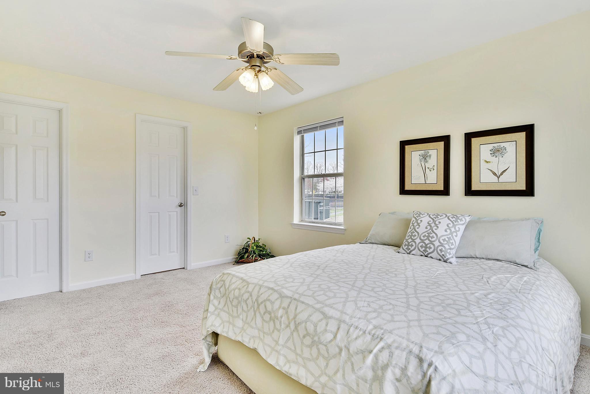14802 Rydell Road, Unit 202 Centreville, VA 20121 - Photo 10 of 27 a bedroom with a large bed and a chandelier