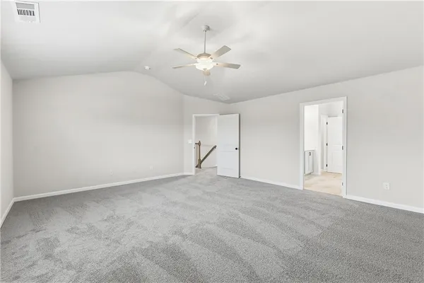 an empty room with a window and a ceiling fan