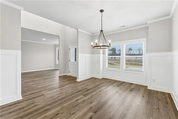 a view of empty room with wooden floor window and wooden floor