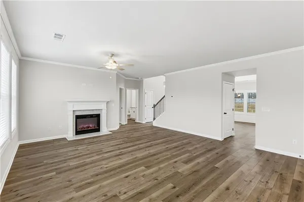 a view of a livingroom with wooden floor and a fireplace