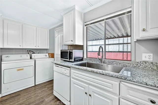 a kitchen with granite countertop a sink and a window