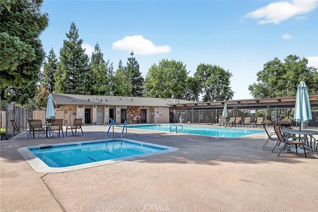 a view of house with swimming pool outdoor seating
