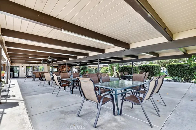 a view of a house with backyard and trees