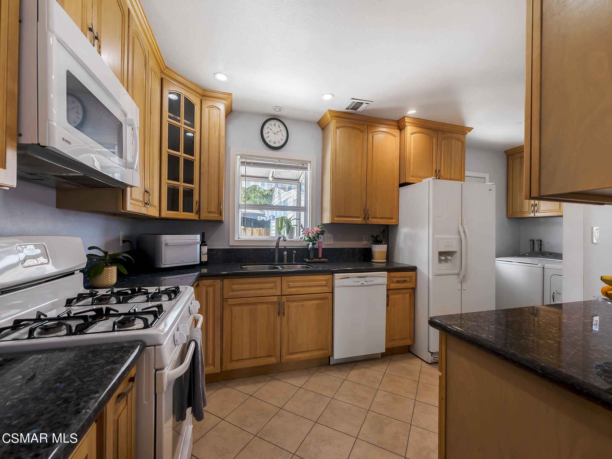 7247 Yolanda Avenue Reseda, CA 91335 - Photo 12 of 33 a kitchen with stainless steel appliances granite countertop a stove a sink dishwasher and a refrigerator