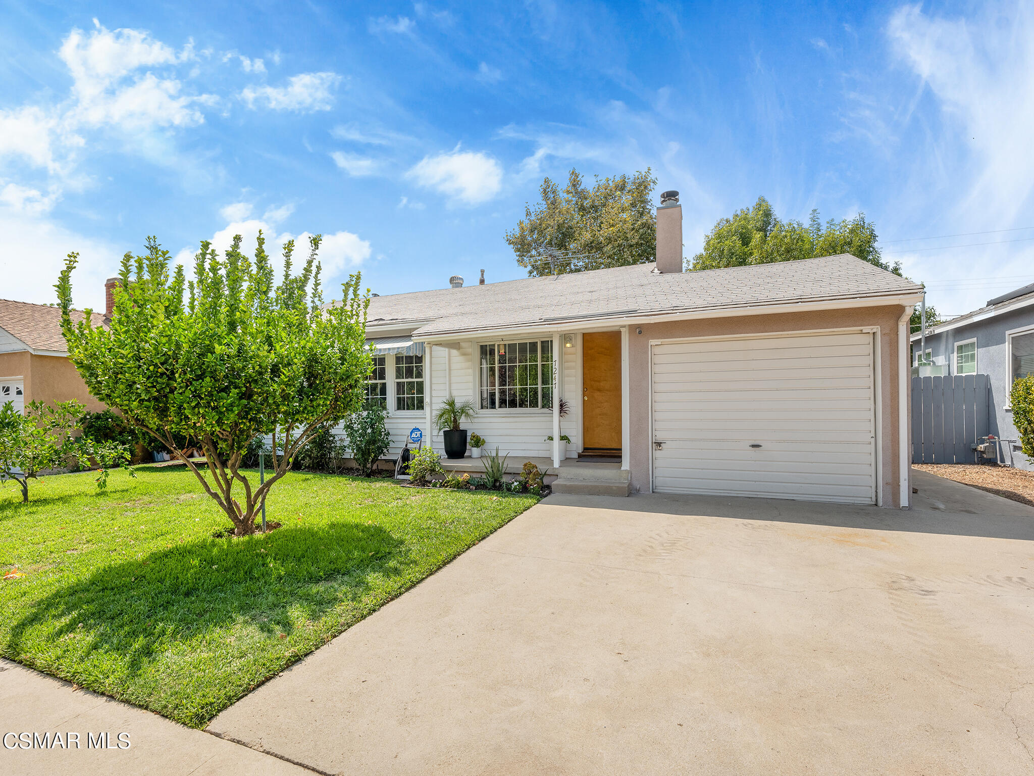 7247 Yolanda Avenue Reseda, CA 91335 - Photo 2 of 33 a front view of a house with a yard and garage