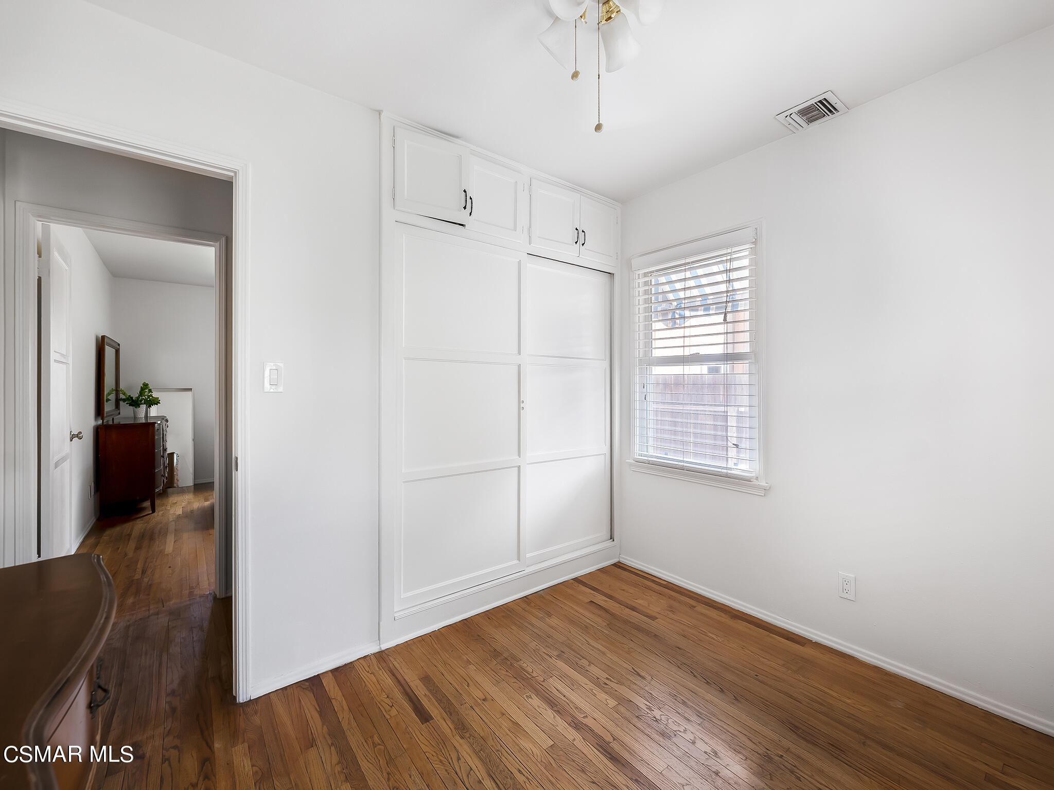 7247 Yolanda Avenue Reseda, CA 91335 - Photo 25 of 33 an empty room with wooden floor cabinet and windows