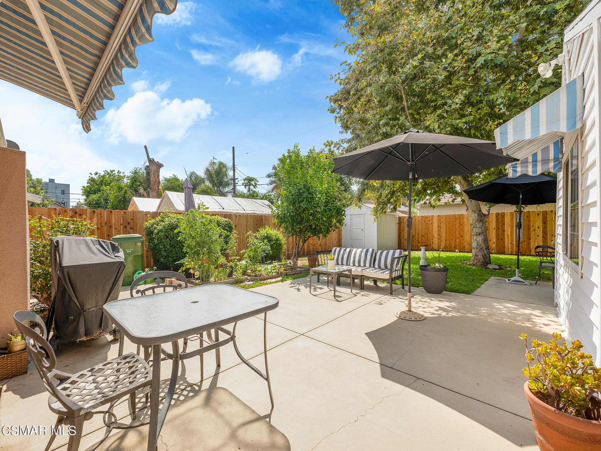 7247 Yolanda Avenue Reseda, CA 91335 - Photo 27 of 33 a view of a patio with a table and chairs under an umbrella