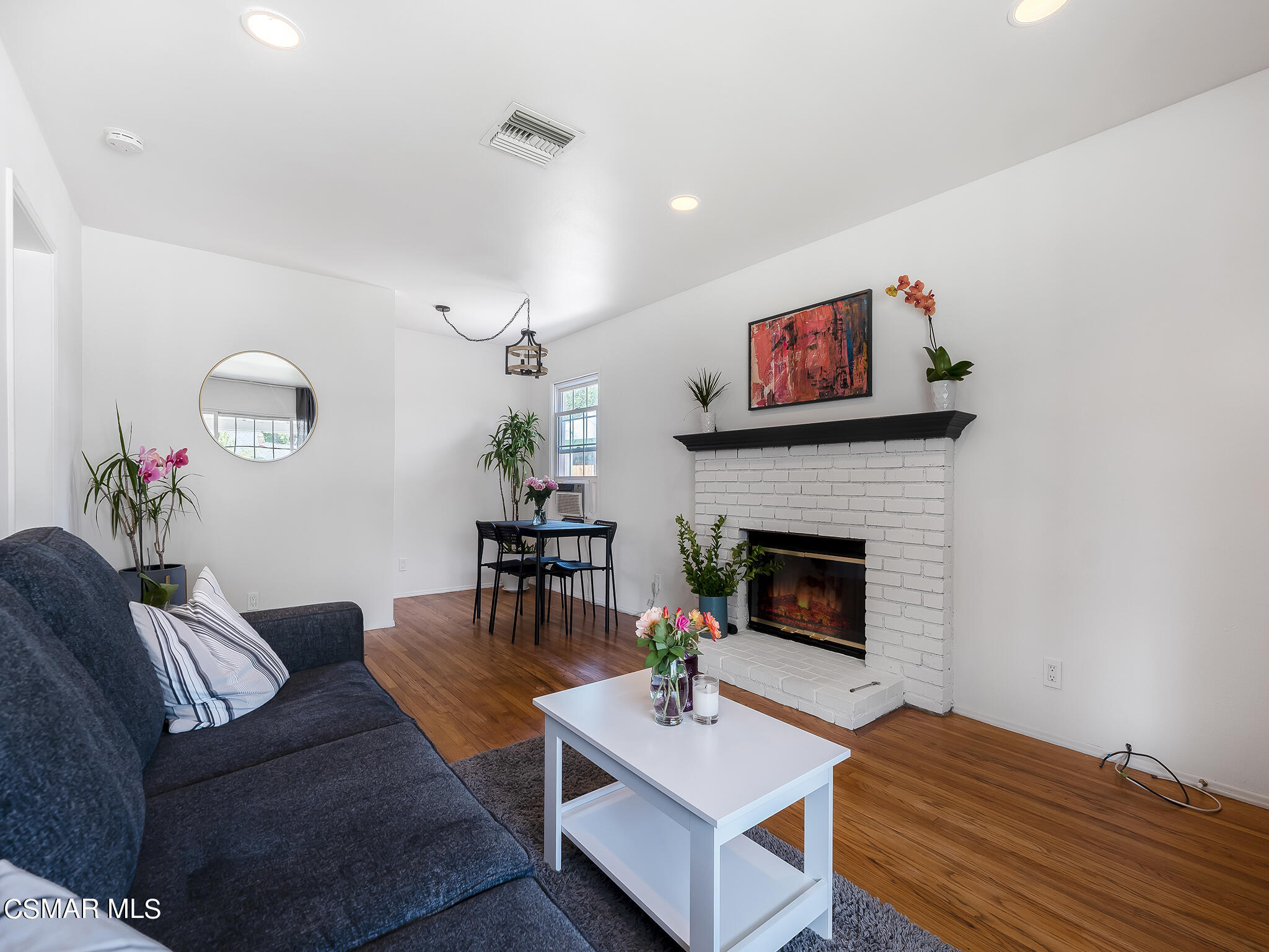 7247 Yolanda Avenue Reseda, CA 91335 - Photo 10 of 33 a living room with furniture a fireplace and a flat screen tv