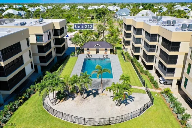an aerial view of a house with a swimming pool and outdoor seating