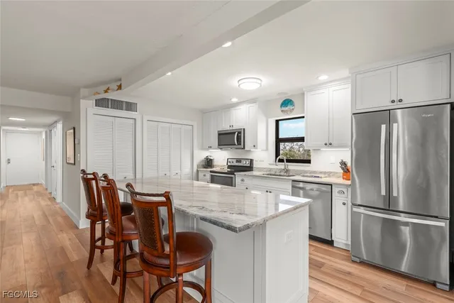 a kitchen with a table chairs refrigerator and microwave