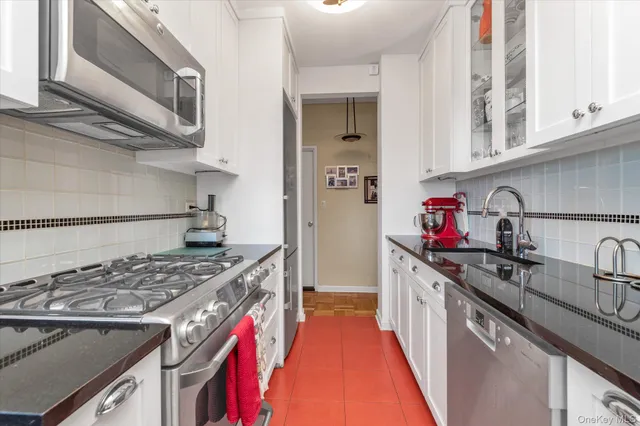 a kitchen with stainless steel appliances granite countertop a stove and a sink