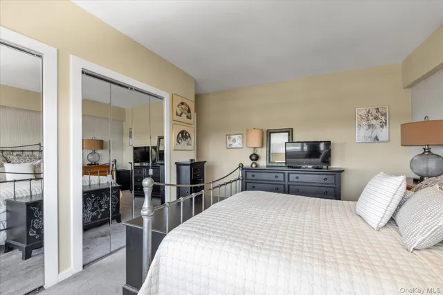 a bedroom with furniture and a flat screen tv