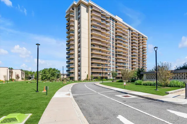 a view of a tall building with a yard