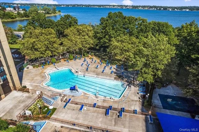 a view of a tennis ground with large trees