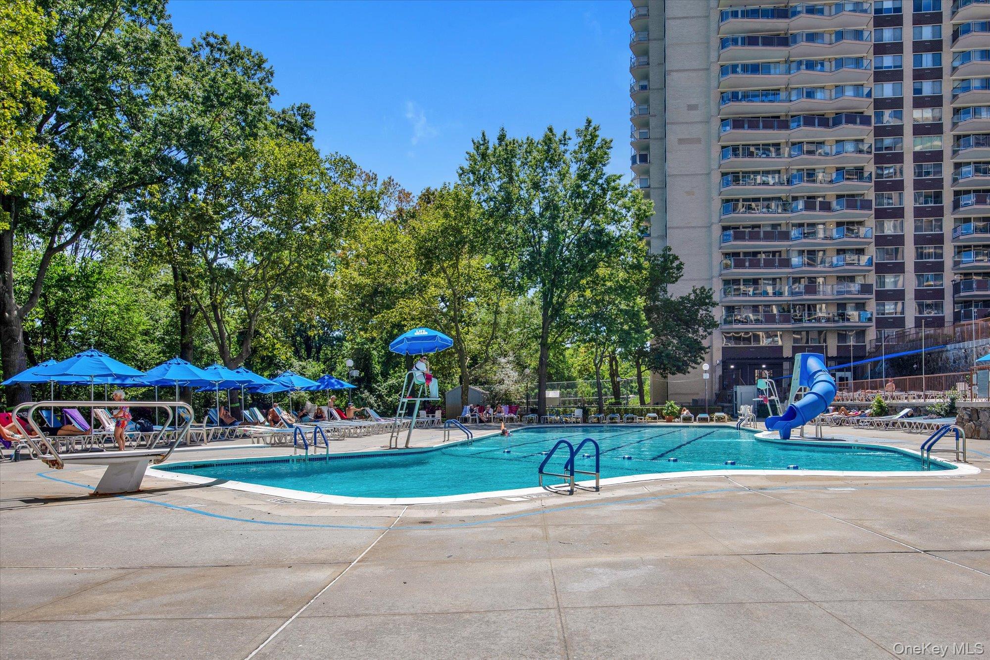 17-85 215th Street, Unit 17E Queens, NY 11360 - Photo 22 of 33 a view of a tennis ground with large trees