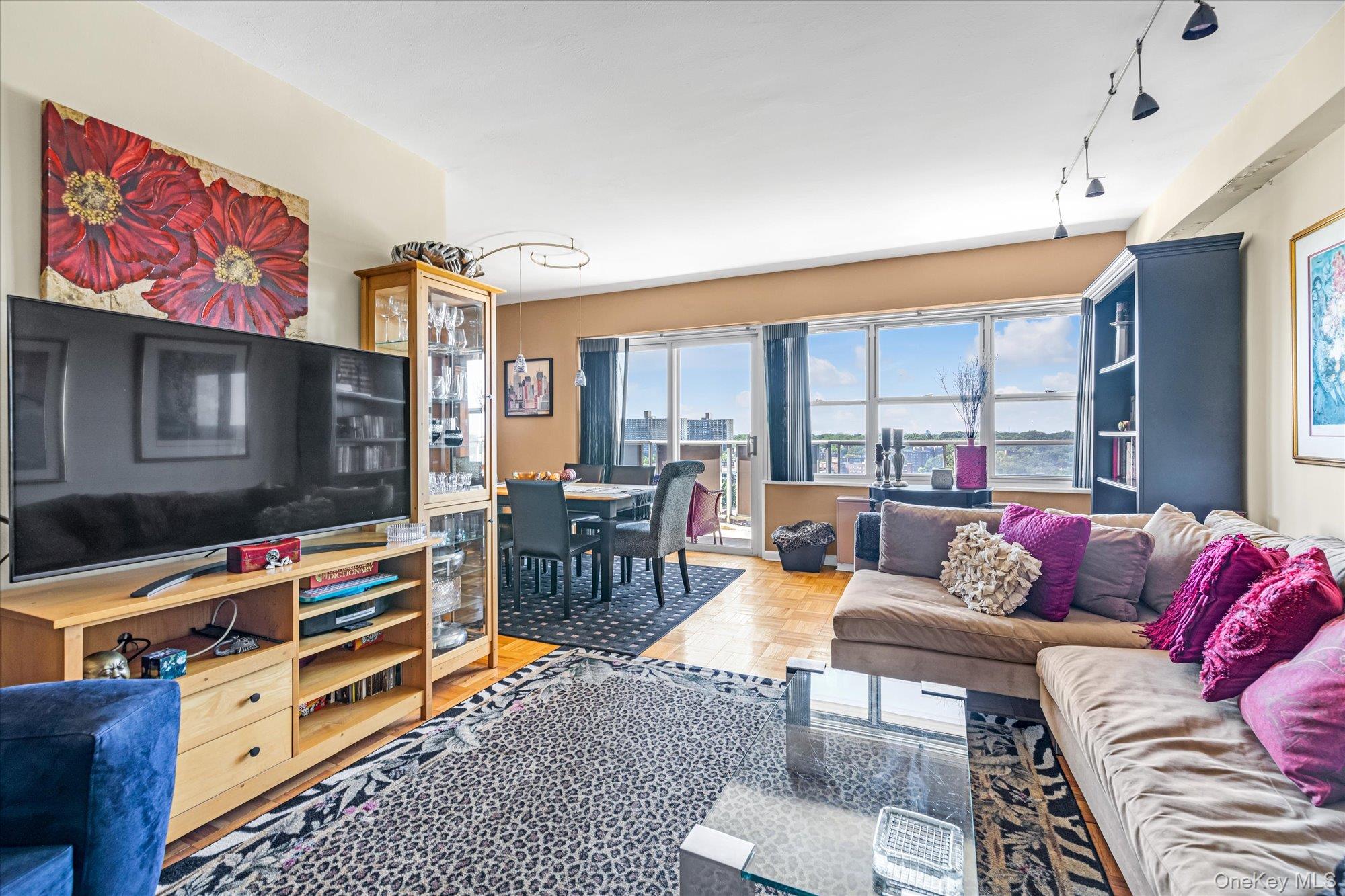 17-85 215th Street, Unit 17E Queens, NY 11360 - Photo 5 of 33 a living room with furniture and a flat screen tv