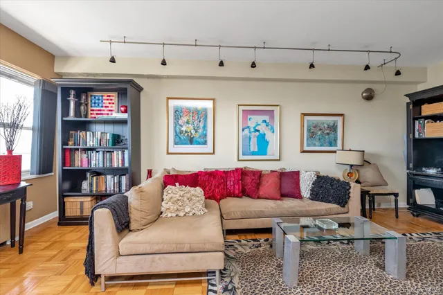 a living room with furniture and a book shelf