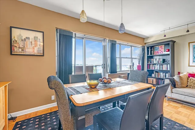 a view of a dining room with furniture window and wooden floor
