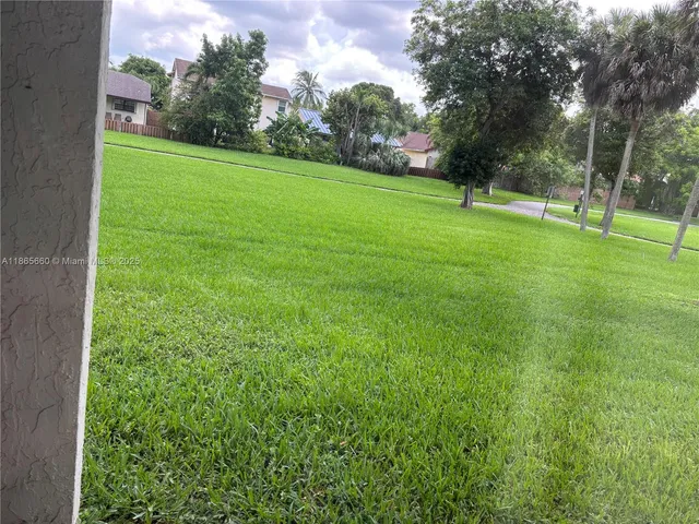a view of field with trees in the background