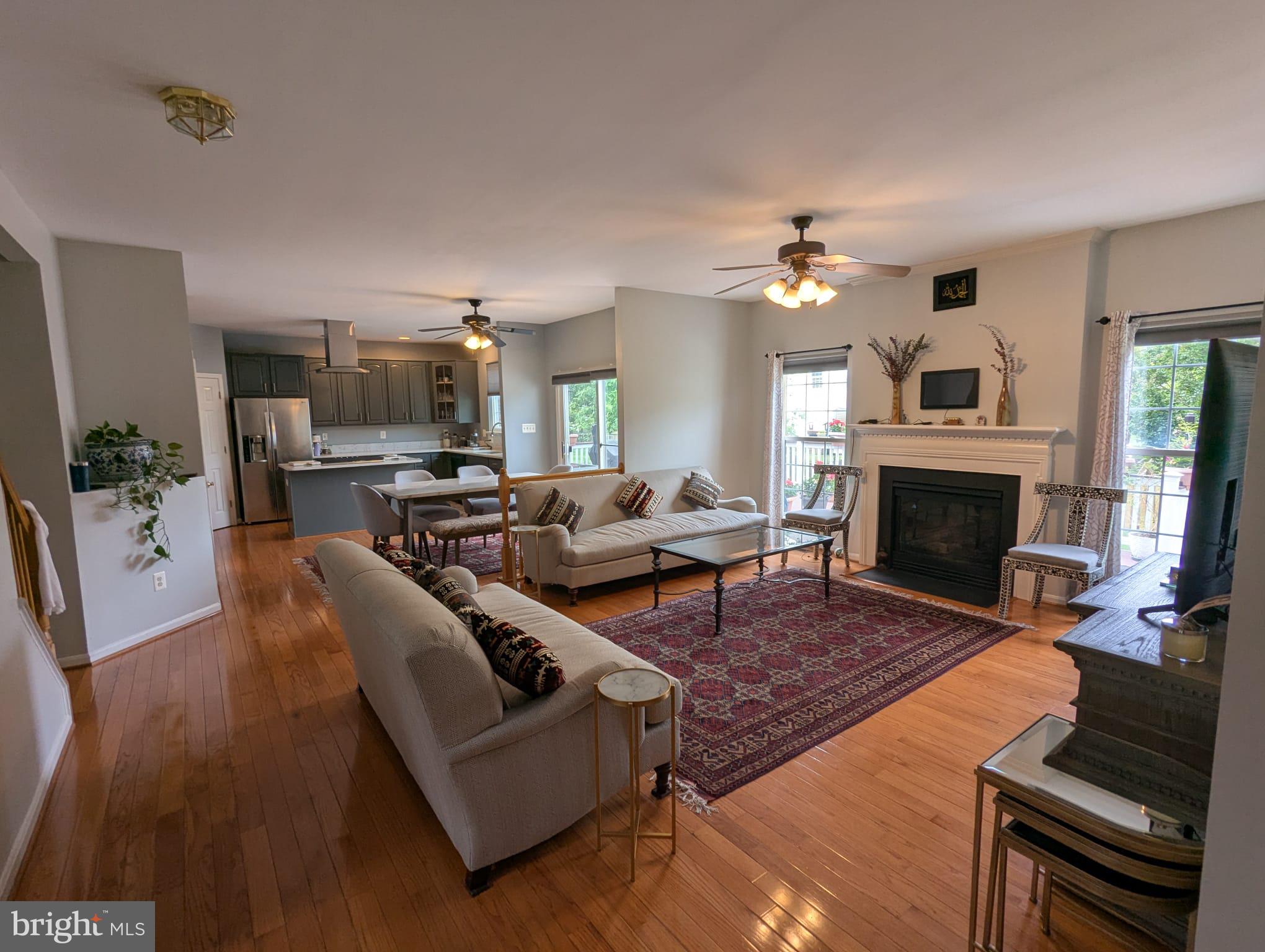 9871 Upper Mill Loop Bristow, VA 20136 - Photo 11 of 84 a living room with furniture a fireplace and a flat screen tv